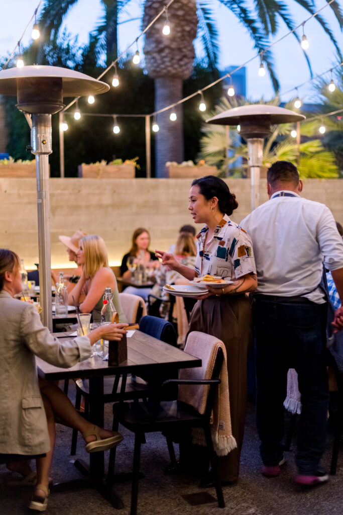 Guests chat with a manager on the busy patio