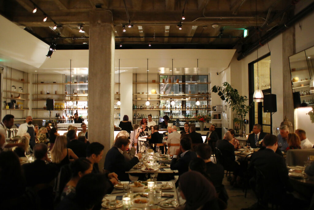 Guests at a LA Chefs for Human Rights Gala dining in the main dining room